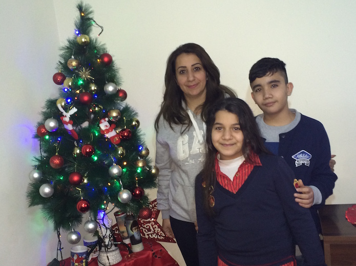 Suha, a Syriac Catholic uprooted from Qaraqosh, Iraq, by the Islamic State in August 2014 with two of her three children. The family is living in exile in Beirut, Lebanon.
