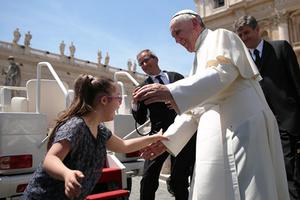 Pope Francis reaches out to greet Grazia, a girl with Down syndrome, during the Wednesday General Audience in St. Peter's Square on May 13, 2015, the feast day of Our Lady of Fatima.