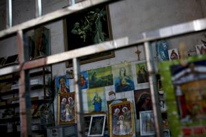 Catholic religious paintings and Bibles are displayed behind bars at an underground Catholic church in Jiexi county in south China's Guangdong province March 27. A group that monitors Christianity in China says the government is ratcheting up a crackdown on congregations in Beijing and several Chinese provinces, destroying crosses, burning Bibles and ordering followers to sign papers renouncing their faith. Churches have also been razed.
