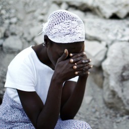 HOW LONG, O LORD? A woman prays in front of the destroyed Cathedral of Our Lady of the Assumption in Port-au-Prince, Haiti, Jan. 12, as Haitians marked the first anniversary of the earthquake that flattened much of the capital. 