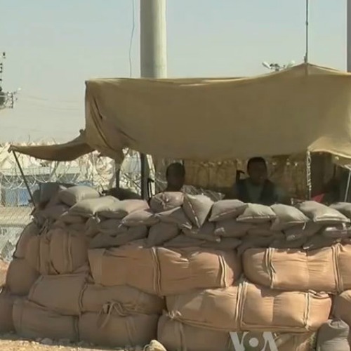 Soldiers stand guard outside at a Syrian refugee center on the Turkish border, about 50 miles from Aleppo, Syria, in August 2012.