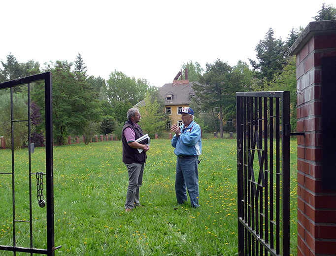After their liberation, dozens of train passengers succumbed to disease and were buried in unmarked graves in the displaced persons camp in Hillersleben, Germany. Frank Towers (right) and Christian Wolpers (Bergen-Belsen museum curator) are pictured in the cemetery on August 3, 2011.