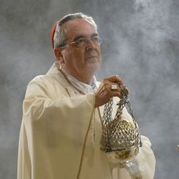 Cardinal Justin Rigali of Philadelphia venerates the crucifix during the opening Mass of the Eucharistic congress sponsored by the Council of Major Superiors of Women Religious at the Basilica of the National Shrine of the Immaculate Conception in Washington Sept. 11, 2009. The congress theme was the Eucharist in the context of Christian vocations to the priesthood, religious life and marriage