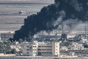 This picture, taken Oct. 13, from the Turkish city of Ceylanpinar shows smoke rising from the Syrian border town of Ras al-Ain as fighting rages along the border on the fifth day of a Turkish offensive in Syria against the Kurdish People's Protection Units (YPG) that has provoked an international outcry and left dozens of civilians and fighters dead. 