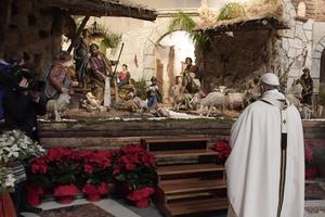 Pope Francis contemplates the Vatican Nativity scene.