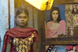 A young prostitute waits for customers in Mumbai's red-light district in India.
