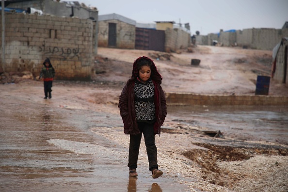 A Syrian girl walks in the mud near makeshift shelters following heavy rains, at a camp for displaced people in the village of Atme, in Syria's mostly rebel-held northern Idlib province Jan. 8. 