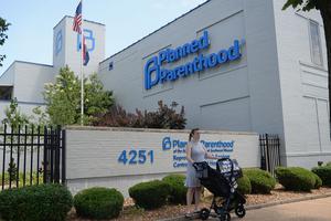 A women stands with her child in a stroller during a pro-life rally outside the Planned Parenthood Reproductive Health Center on June 4, 2019 in St Louis, Missouri. 