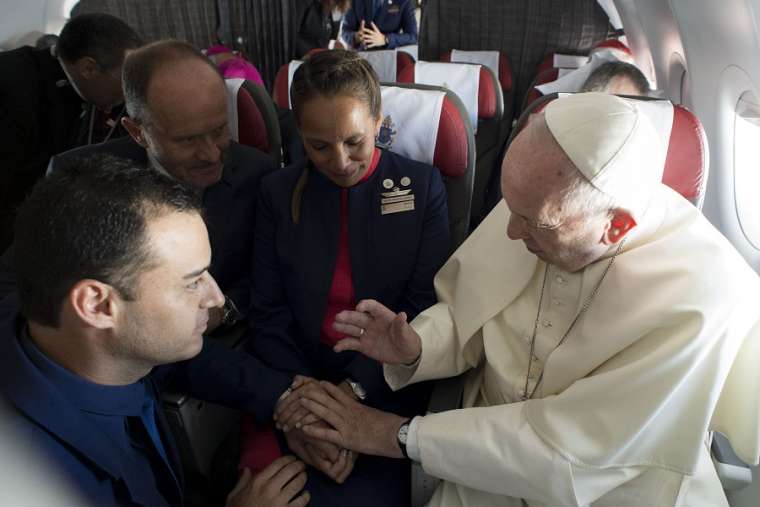 Above, Pope Francis marries flight attendants Paula Podest and Carlos Ciuffardi during his flight from Santiago to Iquique, Chile, Jan. 18. Below: Podest and Ciuffardi. Also below, the marriage certificate was drawn up by cardinals who accompanied the Pope on the flight.