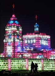 People walk past an ice sculpture of a Catholic church in Harbin, China, Dec. 22.