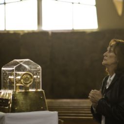 Joyce Gould prays in front of the relic of St. Mary Magdalene Feb. 15 that visited Holy Rosary Church in Antioch, Calif. Seventh-graders from the parish school attended the service. 