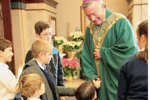 Above, Bishop Peter Christensen greets Catholic schoolchildren at Mass at St. Mark’s Church in Boise, Idaho. 