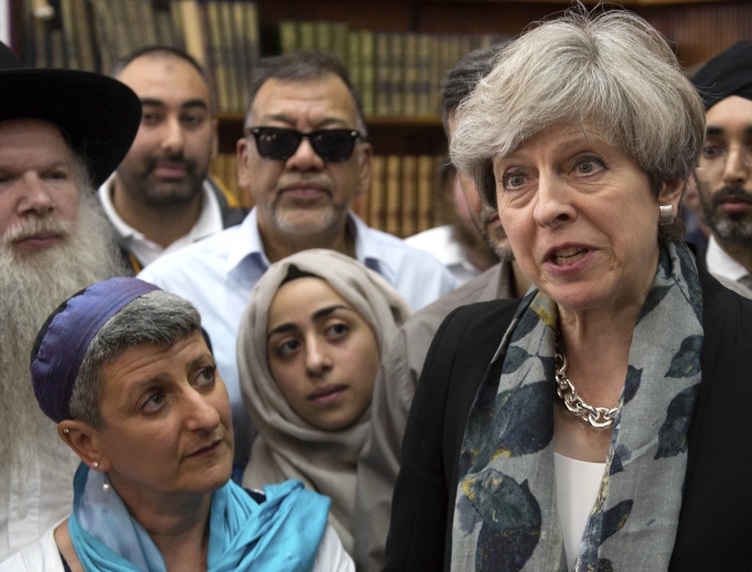 British Prime Minister Theresa May (r), talks to faith leaders at Finsbury Park Mosque in north London June 19, after a man drove his vehicle into a crowd of worshippers outside a north London mosque, injuring at least nine people. The prime minister announced the plan to create an anti-extremism commission earlier this year, but Christians and others worry about how it will affect their own civil liberties. 