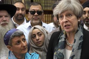 British Prime Minister Theresa May (r), talks to faith leaders at Finsbury Park Mosque in north London June 19, after a man drove his vehicle into a crowd of worshippers outside a north London mosque, injuring at least nine people. The prime minister announced the plan to create an anti-extremism commission earlier this year, but Christians and others worry about how it will affect their own civil liberties. 
