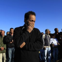 Libyans mourn at martyrs' cemetery in Tripoli March 20 during funerals for people found dead following airstrikes by coalition forces.  