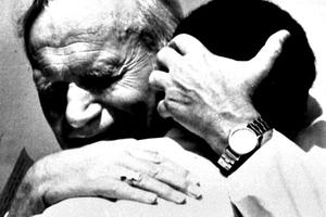 Pope John Paul II hugs a young Mauritius child on Oct. 16, 1989, during his visit to Mauritius.

