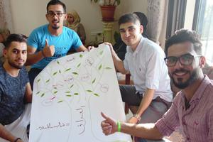 Iraqi youth of different faiths who participated in a workshop in Lebanon by Adyan, a Lebanese foundation for interreligious studies and spiritual solidarity, display the 'tree of diversity in Iraq' they drew. Below, participants pose with their certificates awarded by Adyan at the conclusion of the workshop. 
