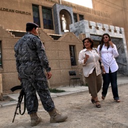 ENDANGERED SPECIES? An Iraqi police officer stands guard outside of St. Joseph Chaldean Church in Baghdad following a Sunday liturgy on July 24. Forming one of the oldest Christian communities of the Middle East, Iraqi Christians have been targeted for attack since 2003, with numerous abductions, murders and threats for them to leave Iraq. In 1980 Iraqi Christians made up over 7% of the population and have now declined to below 3%. St. Joseph, which was established in 1959 and which once had as many as 1,200 families in its parish, now has only 150 to 200 families left.