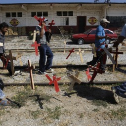 Guatemalan migrants carrying wooden crosses march along train tracks to raise awareness of violence toward migrants in Arriaga, Mexico, Jan. 7. Countless Latin American migrants journey some 1,900 miles through Mexico hoping for a better life in the United States. Many see their journey end in robbery, assault, abduction or arrest. 