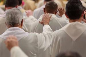 Priests concelebrate with Pope Francis during the chrism Mass in St. Peter's Basilica on March 24.