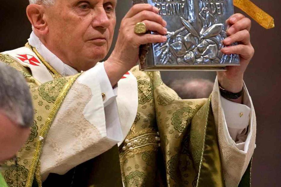 The Pope holds the Book of the Gospels at this year's Synod.