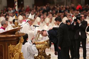 Pope Francis baptizes a catechumen at the Easter Vigil Mass in St. Peter's Basilica on April 4, 2015.
