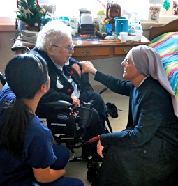 Mother Patricia Mary, right, and nurse Friary Nguyen visit 99-year-old resident Helen Reichenbach Jan. 2 in her room at the Mullen Home for the Aged, run by Little Sisters of the Poor, in Denver. 