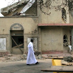 Msgr. Obiora Ike walks in front of St. Leo the Great Catholic Church in Enugu, Nigeria.