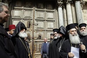 Greek Orthodox Patriarch of the Holy Land Theophilos III, second right, stands outside the closed doors of the Church of the Holy Sepulcher, traditionally believed by many Christians to be the site of the crucifixion and burial of Jesus Christ, in Jerusalem, Feb. 25. The leaders of the major Christian sects in Jerusalem closed the Church of the Holy Sepulcher for several hours on Sunday to protest an Israeli plan to tax their properties. 