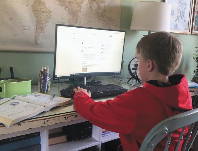 A sixth-grade student from Our Lady of Mount Carmel School in Carmel, Indiana, attends class online during the coronavirus shutdown. 