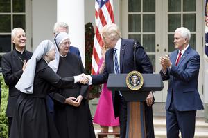 President Donald Trump greets on stage the Little Sisters of the Poor, flanked by Cardinal Donald Wuerl of Washington and Vice President Mike Pence, before signing the executive order on promoting free speech and religious liberty during a National Day of Prayer event in the Rose Garden of the White House in Washington, D.C., May 4. 