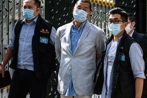 Hong Kong police lead pro-democracy media mogul Jimmy Lai (c), 72, a Catholic, away from his home after he was arrested under the new national security law in Hong Kong Aug. 10. Chinese police also raided his newspaper offices in a deepening crackdown on dissent. 
