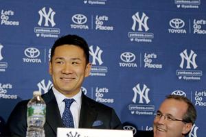 Above, George Rose (r) during pitcher Masahiro Tanaka’s introductory news conference with the Yankees in 2014. Below, Rose (c) with his son, Sean, and wife, Carrie, in front of the sarcophagus of Blessed Father Michael Sopocko, above which hangs his portrait. This was taken in April of this year during a pilgrimage to the Divine Mercy Sanctuary in Bialystok, Poland. The Roses are seeking the blessed's intercession for George's cancer.