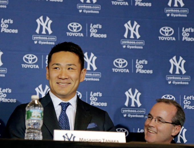 Above, George Rose (r) during pitcher Masahiro Tanaka’s introductory news conference with the Yankees in 2014. Below, Rose (c) with his son, Sean, and wife, Carrie, in front of the sarcophagus of Blessed Father Michael Sopocko, above which hangs his portrait. This was taken in April of this year during a pilgrimage to the Divine Mercy Sanctuary in Bialystok, Poland. The Roses are seeking the blessed's intercession for George's cancer.