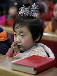 A girl prays during a special Mass for children in Taiyuan, China, in December 2007.