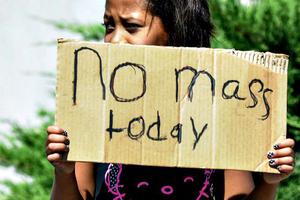 Aaliyah Doninguez, 11, stands on North Alameda Boulevard on Aug. 2 in Las Cruces, N.M., advising parishioners that Holy Cross Catholic Church Mass is canceled. Churchgoers were left shaken during Sunday-morning services after authorities say explosions occurred less than 30 minutes apart outside of two Las Cruces churches.