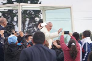 Above, Pope Francis greets crowds at Mass Sept. 7 in Bogotá, Colombia. Below, the faithful listen to his homily.