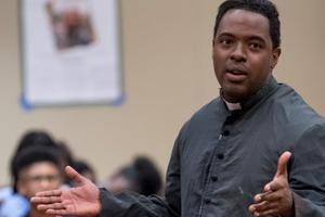 Above, Andrae Goodnight performed at the National Black Catholic Congress this summer. Below, Goodnight, wearing chasuble, with Leonardo Defilippis, St. Luke Productions’ president and founder. 