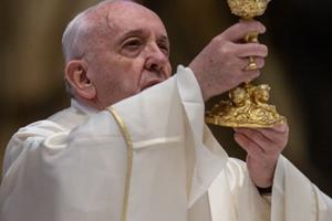 Pope Francis raises the chalice during the Solemn Mass of the Lord's Supper on April 9, 2020. 