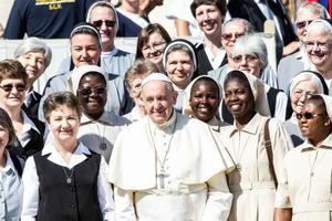Pope Francis smiles with sisters at his general audience Sept. 11. 