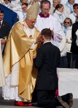 Pope Benedict XVI blesses a pilgrim at Lourdes.