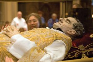 A glass casket with a wax replica of St. John Bosco contains relics of the saint on display at Sts. Peter and Paul Church in San Francisco Sept. 13. The relics are on a worldwide tour to mark the 200th anniversary of the saint's birth near Turin, Italy. 