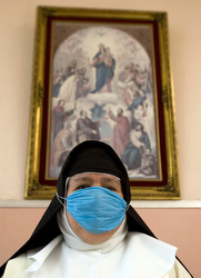A nun at a Mexico City convent listens to Sunday Mass on the radio April 26.