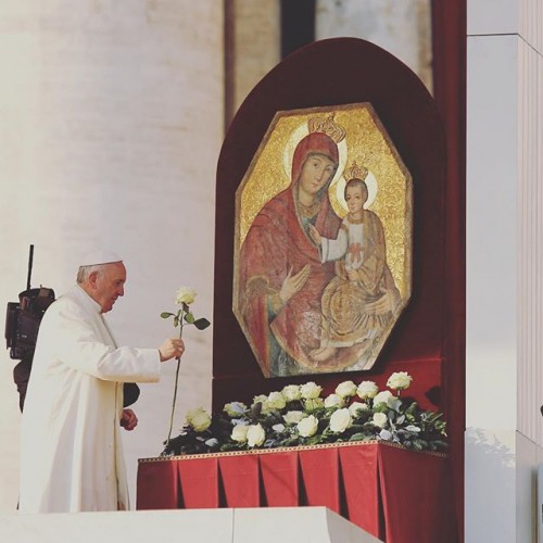 Pope Francis offers a flower to Mary and Jesus on Dec. 9.