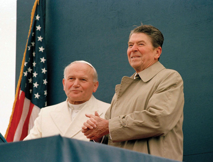 President Ronald Reagan smiles at the crowd as Pope John Paul II stands by his side during a joint appearance at the airport in Fairbanks, Alaska, May 2, 1984. 