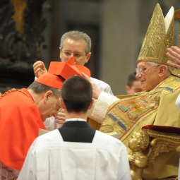 AUSPICIOUS DAY. Pope Benedict XVI
bestows a red biretta, a four-cornered hat,
on the head of new Cardinal Raymond Burke
of the United States during a consistory
ceremony in St. Peter’s Basilica. Twenty-two
men will receive the red hat Feb. 18.

