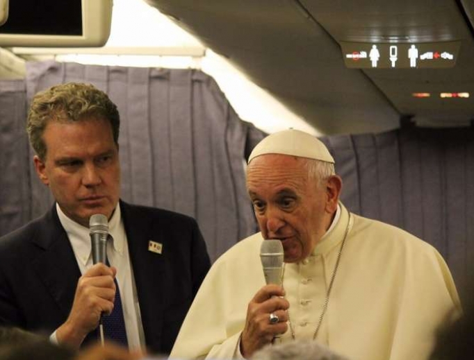 Pope Francis speaks aboard the papal plane from Lima, Peru, to Rome Jan. 22. 
