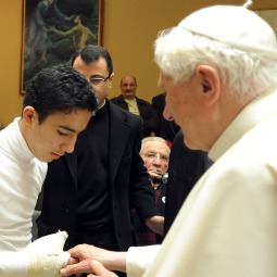 Pope Benedict XVI greets a young man at the Vatican Dec. 1 who was injured when the Syrian Catholic cathedral in Baghdad, Iraq, was attacked Oct. 31. The Italian foreign ministry arranged for 26 injured Iraqis, including three children, and 21 accompanying family members to fly to Rome for treatment of their injuries soon after the incident. 