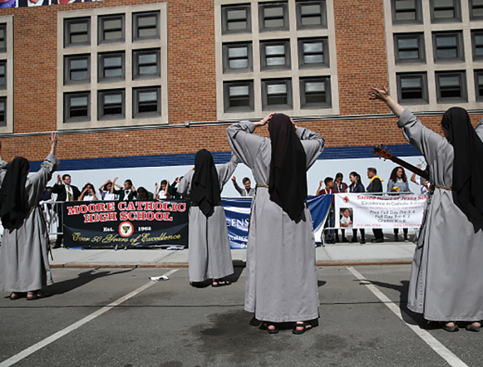 Nuns lead school children in song before the arrival of the Pope Francis at Our Lady Queen of Angels school on Sept. 25, 2015 in the Harlem neighborhood of New York City.
