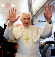 The Pope waves at the end of his airborne news conference.
